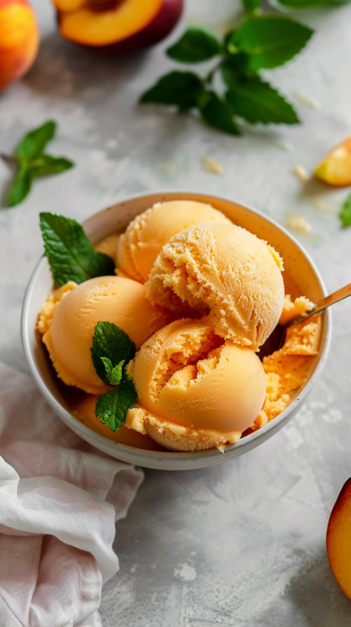 Serving of Peach Sorbet in a bowl with fresh mint