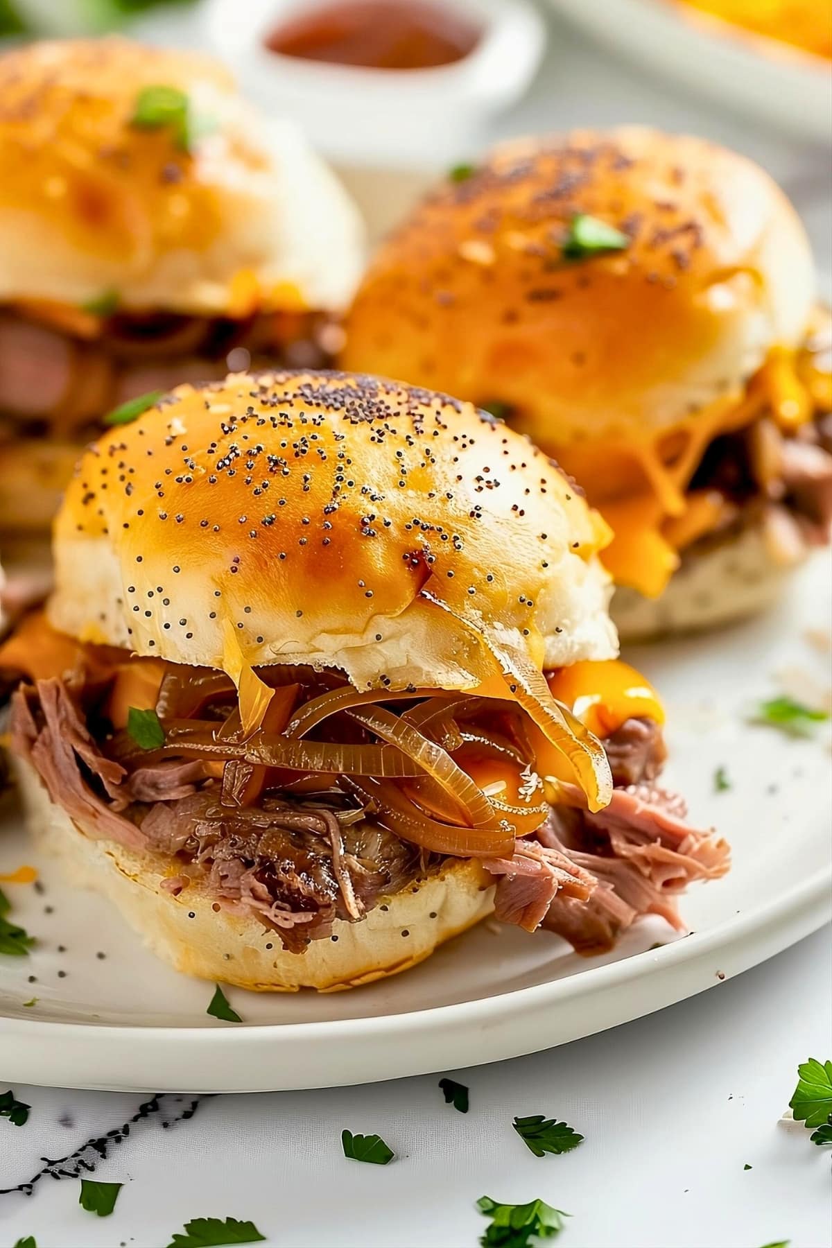 Slider buns with roasted beef and cheese filling.