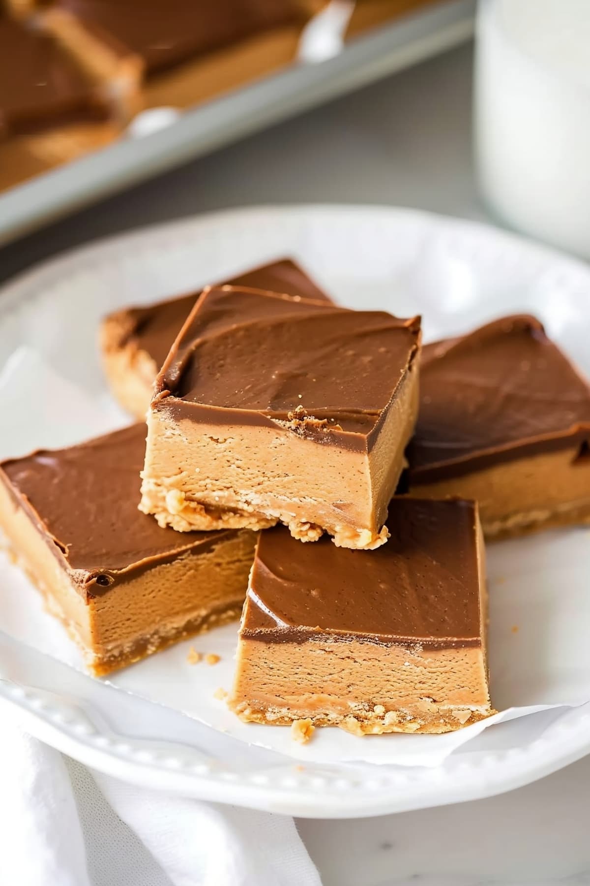 Stacked homemade peanut butter bars served with milk
