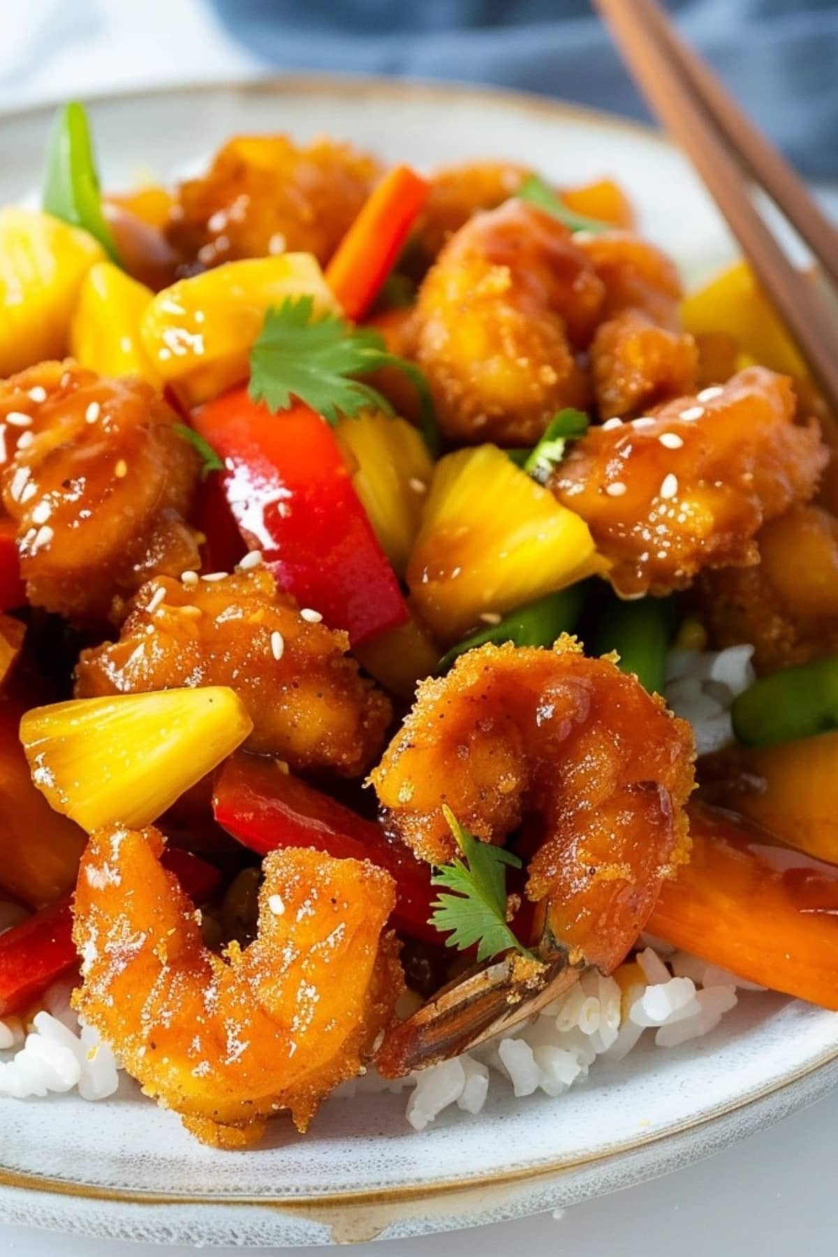 Shrimp with bell pepper, carrots, pineapple chunks and sweet and sour sauce served with rice.