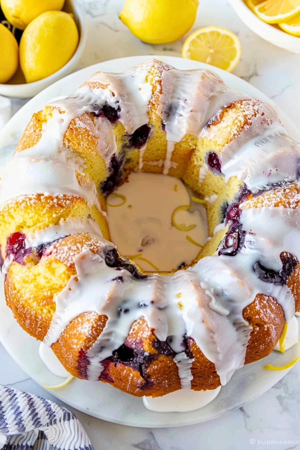 Top view of lemon blueberry pound cake with white glaze on top. 