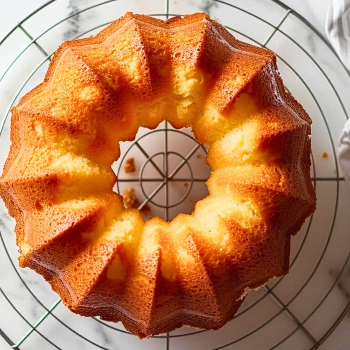Top view of million dollar pound cake on a cooling rack.