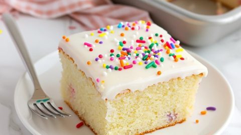 Vanilla sheet cake slice in a white plate.