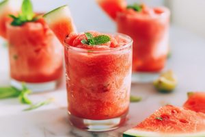 Three glasses of cool and refreshing watermelon slushie with a hint of mint and lime juice