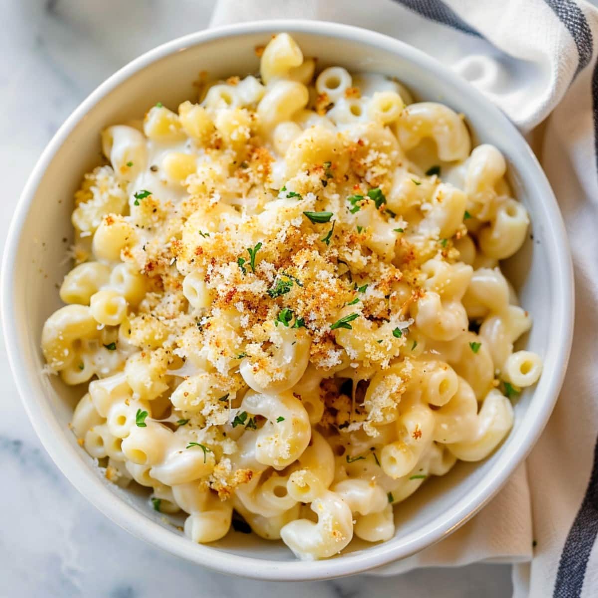Indulgent white cheddar mac and cheese topped with panko crumbs