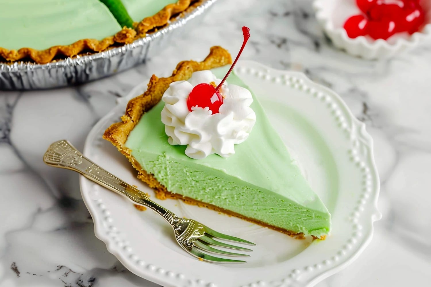 Sliced shamrock shake pie topped with whipped cream and maraschino cherry, a delicious twist on a classic dessert favorite