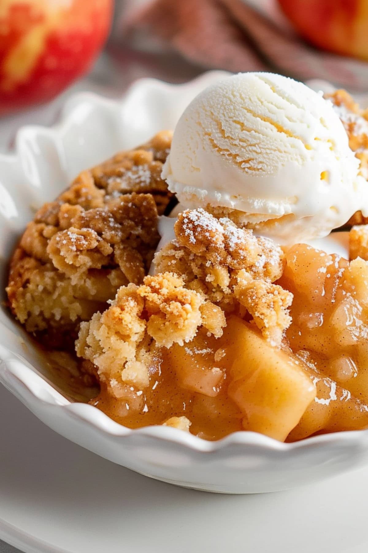 A classic apple cobbler with a dollop of vanilla ice cream melting on top, creating a delightful contrast of warm and cold.