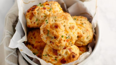 A bowl of homemade buttery and cheesy bacon cheddar biscuits