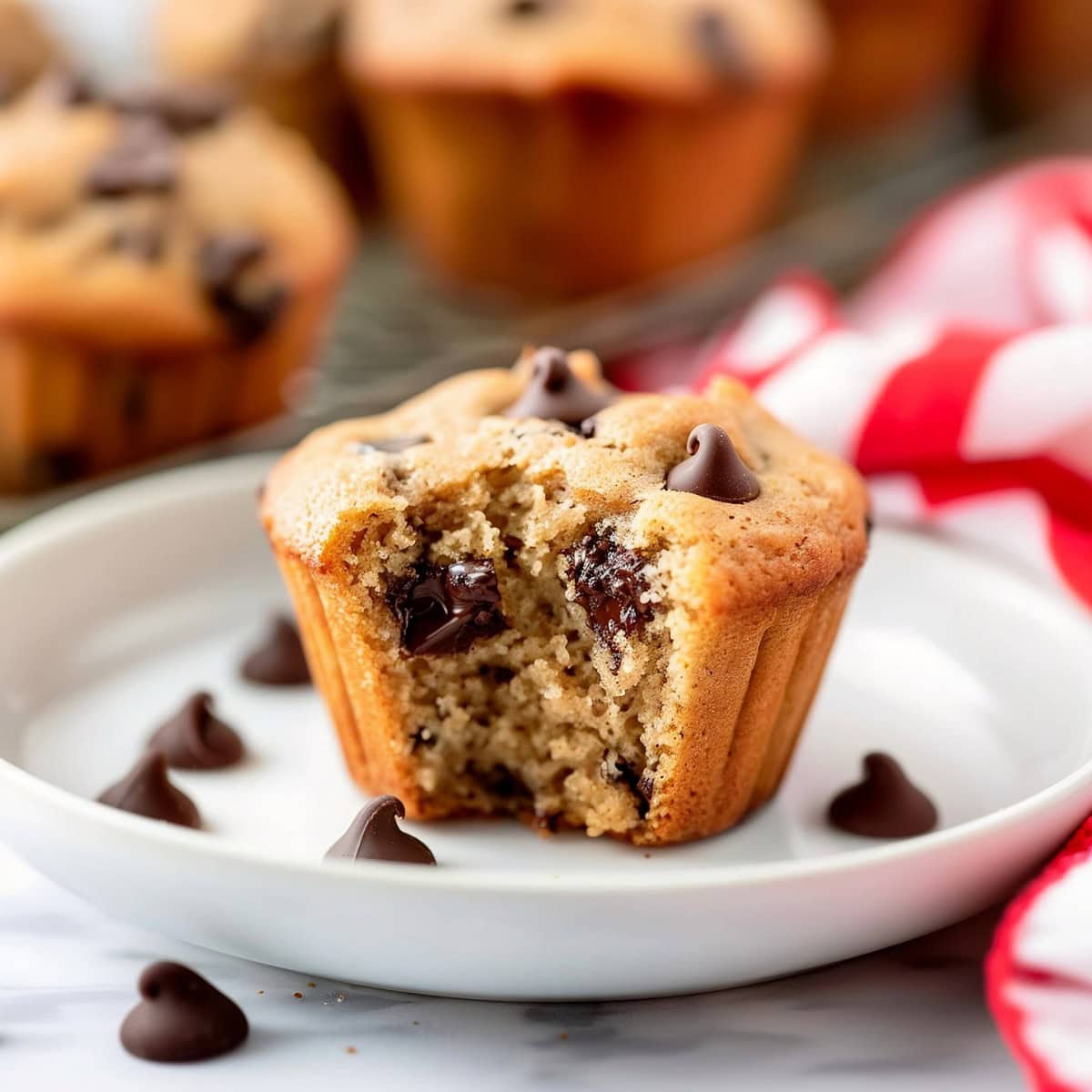 Moist and gooey peanut butter chocolate chip muffins in a white plate
