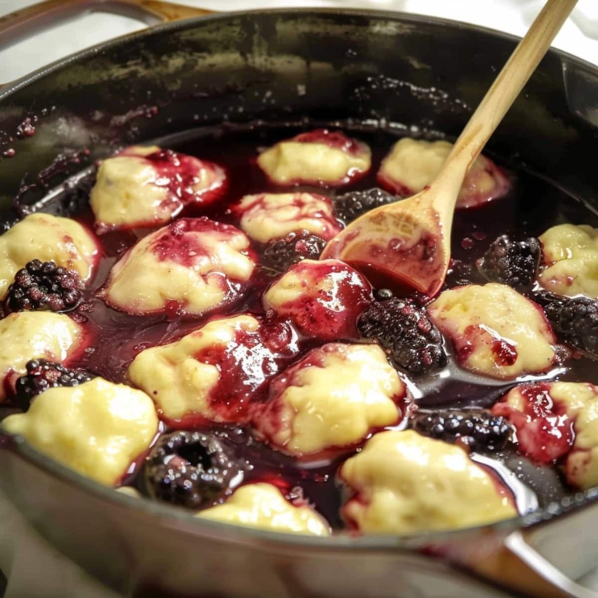 Blackberry dumplings cooked in a Dutch oven pot.