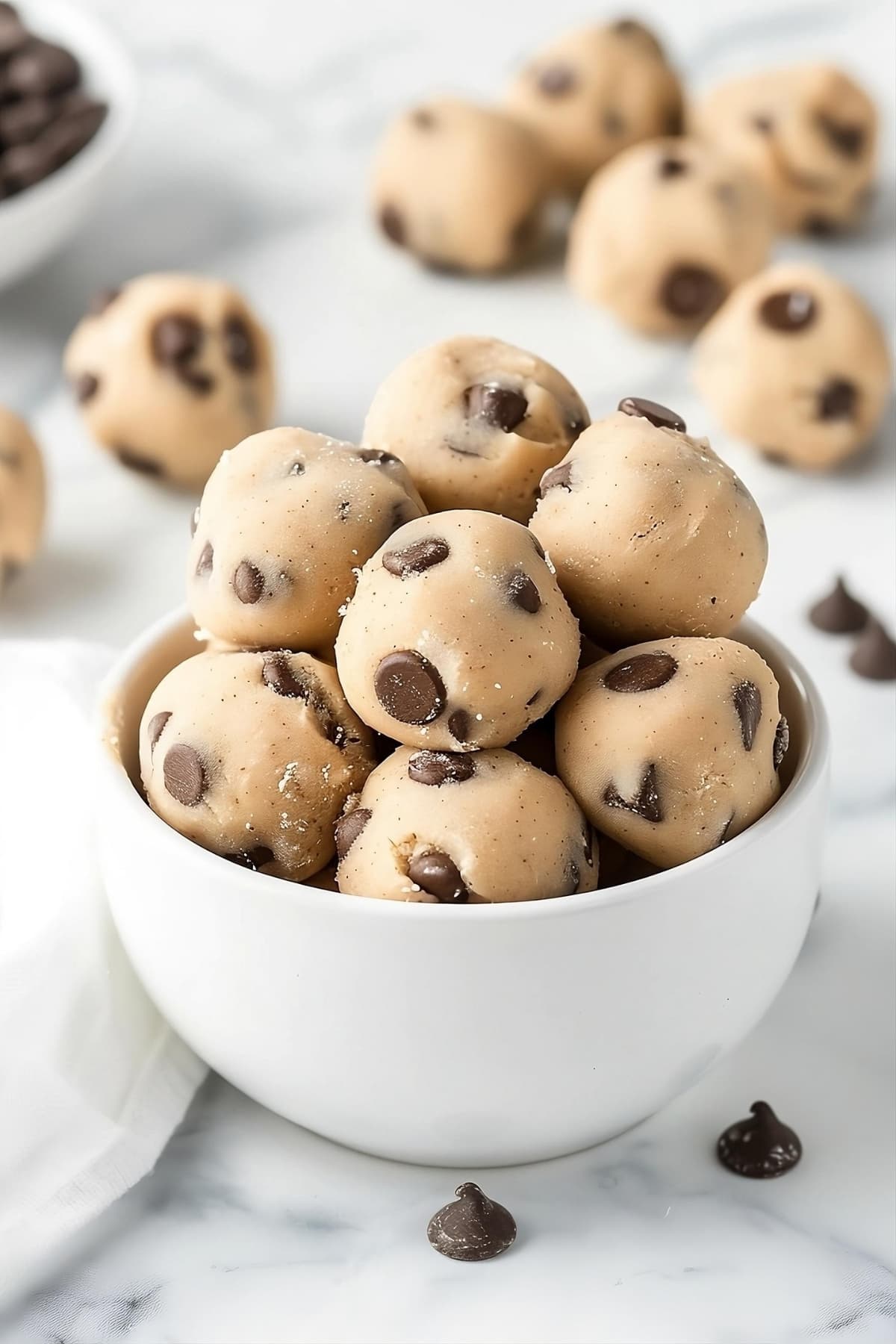 White bowl filled with no bake cookie dough bites.