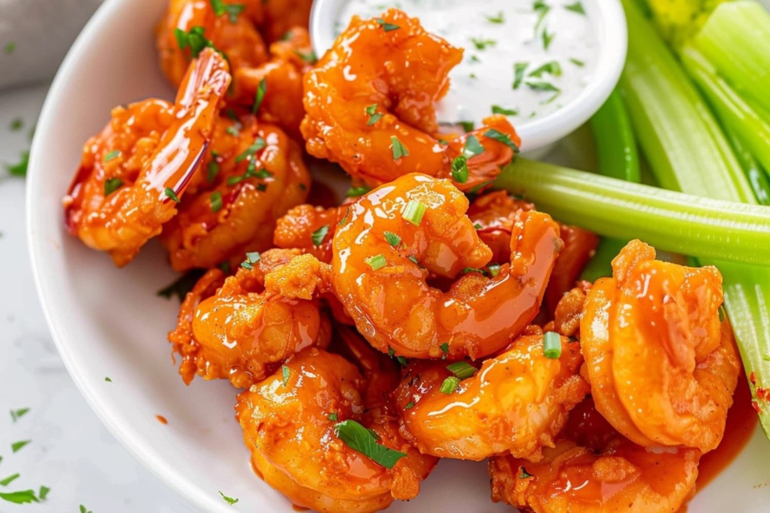 Fried shrimp in buffalo sauce served with ranch dressing and celery sticks.