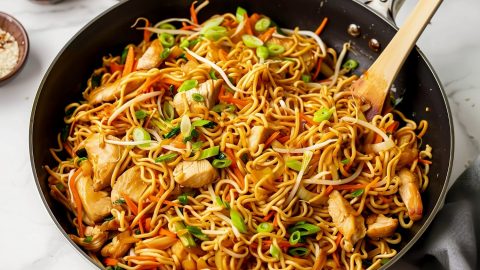 Chicken chow mein noodles with colorful vegetables in a pan