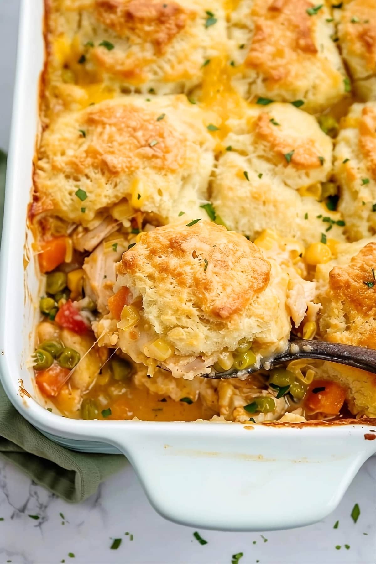 Chicken and biscuit casserole in a white baking dish.
