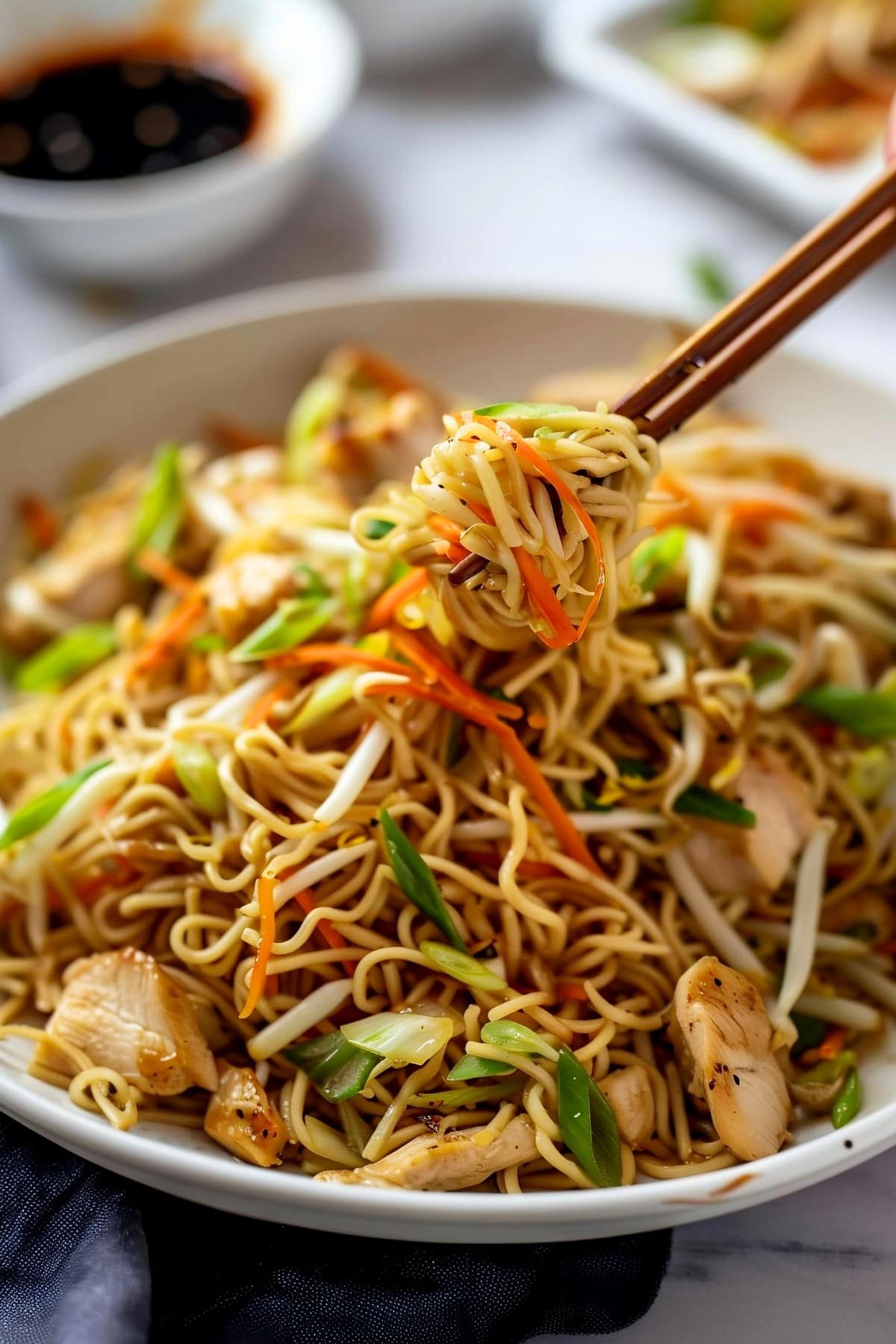 A savory plate of chicken chow mein, featuring vibrant vegetables and thin noodles