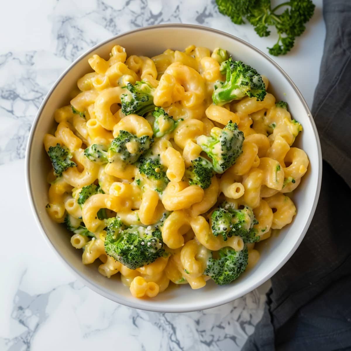 Homemade broccoli mac and cheese, featuring gooey melted cheddar enveloping perfectly cooked macaroni