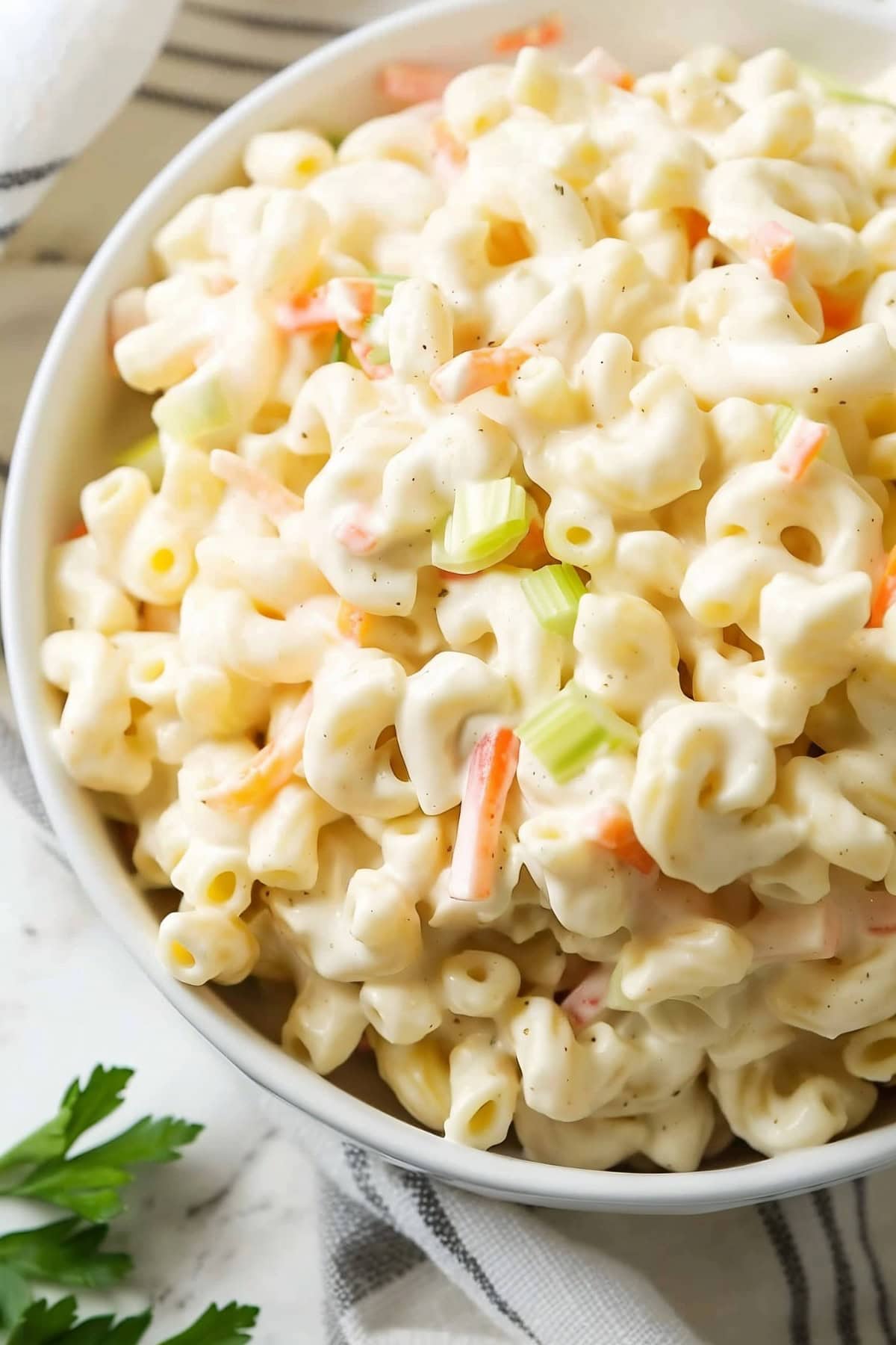 Mouthwatering Hawaiian macaroni salad, a refreshing blend of pasta, carrots, and onions in a creamy dressing