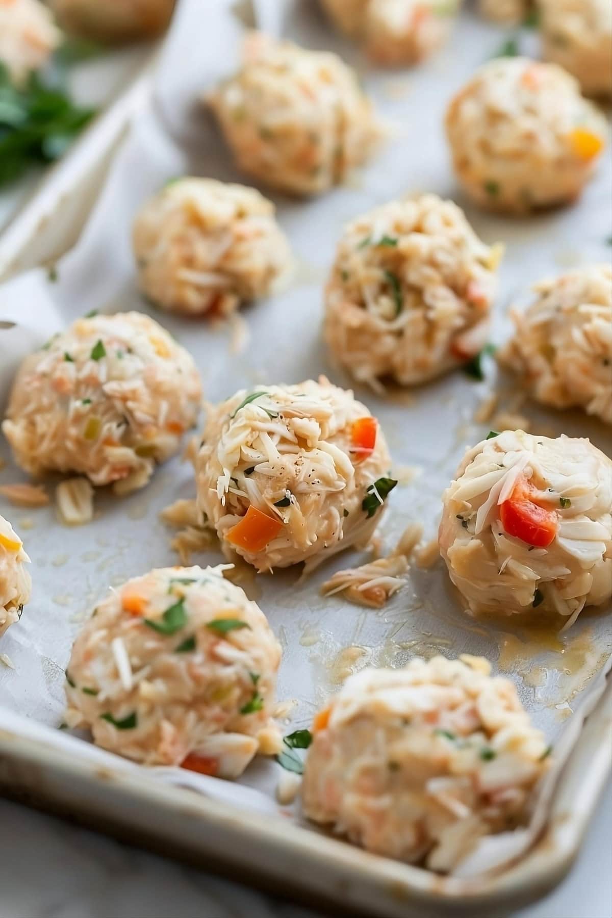 Raw crab balls in a baking dish.