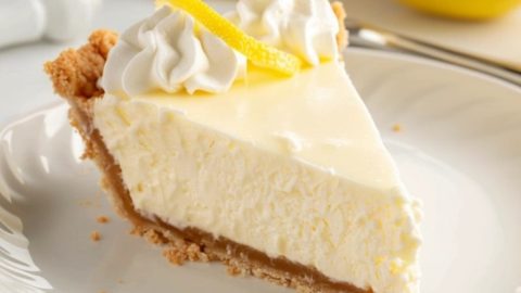 Slice of creamy cream cheese lemonade pie in a white plate.