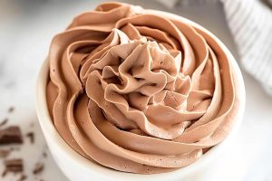 Creamy chocolate whipped cream in a small white bowl.