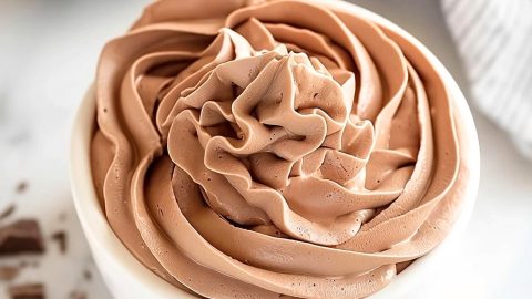 Creamy chocolate whipped cream in a small white bowl.