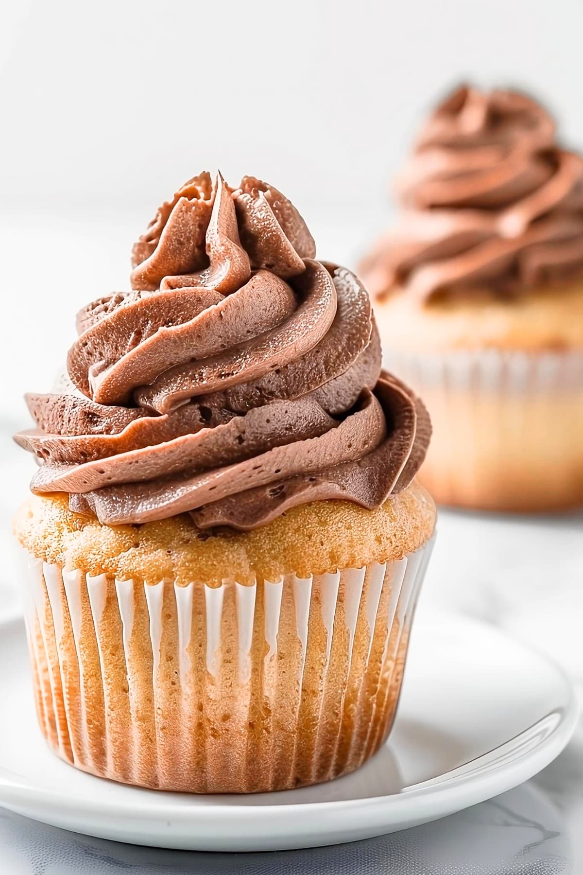 Cupcake topped with chocolate whipped cream.