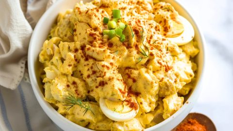 Mouthwatering deviled egg-inspired potato salad, garnished with dill and paprika for an extra pop of flavor