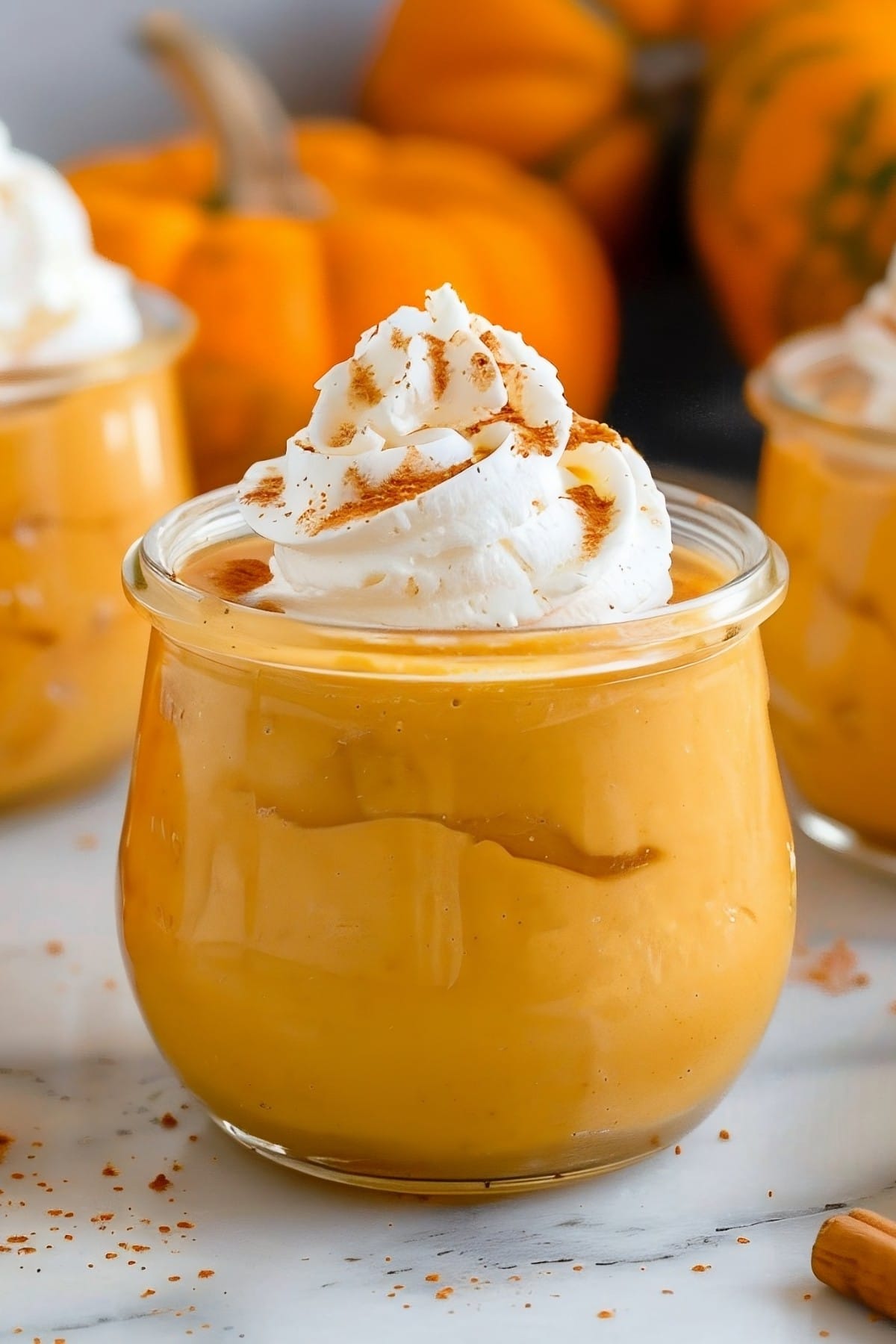 Fluffy and creamy homemade no-bake pumpkin mousse with whipped cream on top