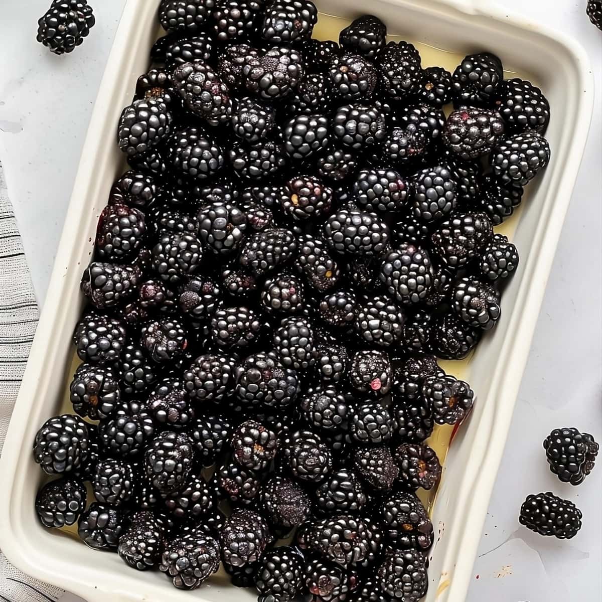 Fresh blackberries on baking dish.