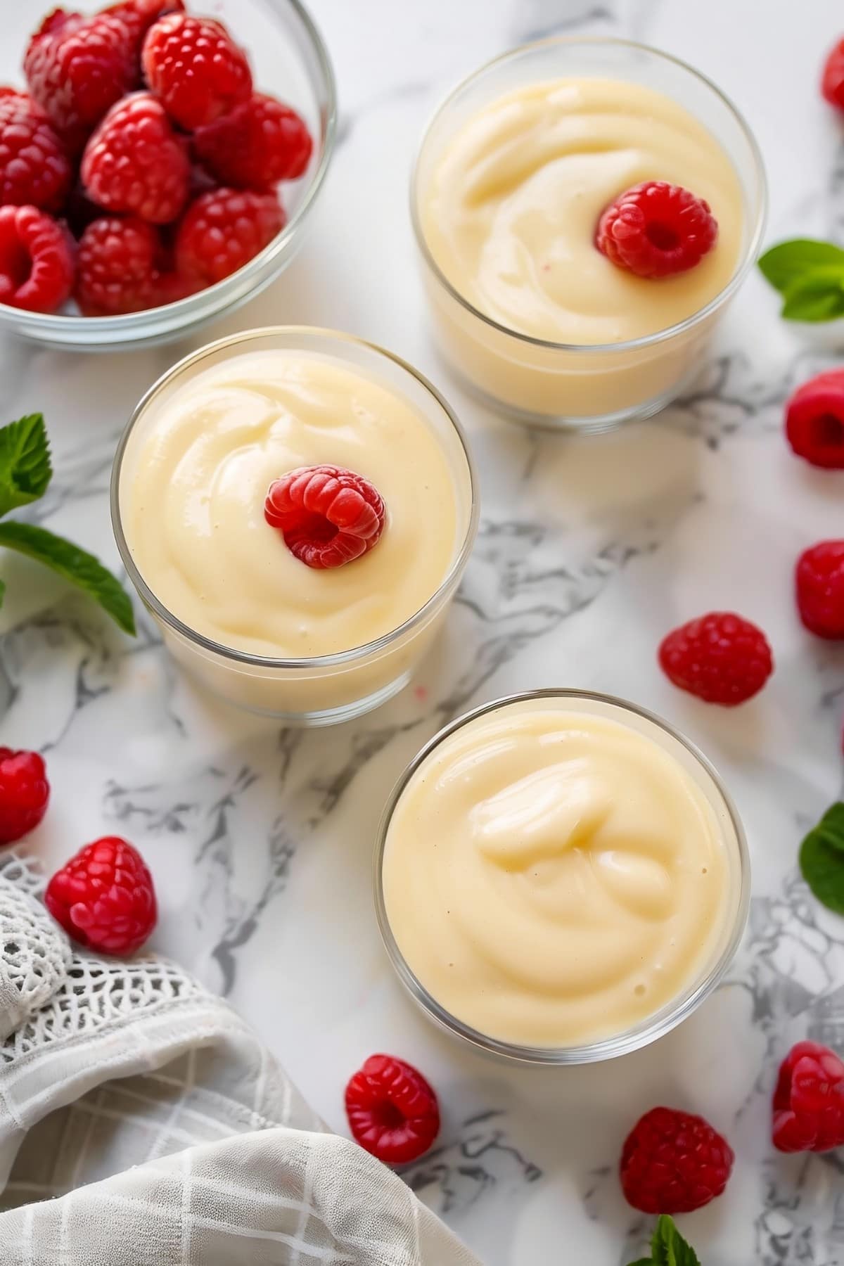 A mouthwatering bowl of vanilla custard with raspberries, exuding warmth and comfort with every spoonful