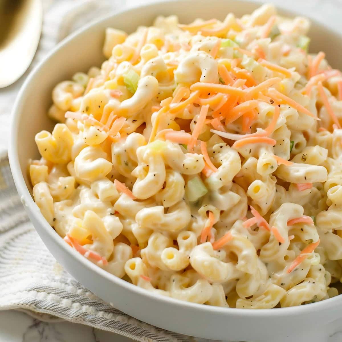 Delicious macaroni salad with a Hawaiian twist, combining carrots, celery, and chopped onions