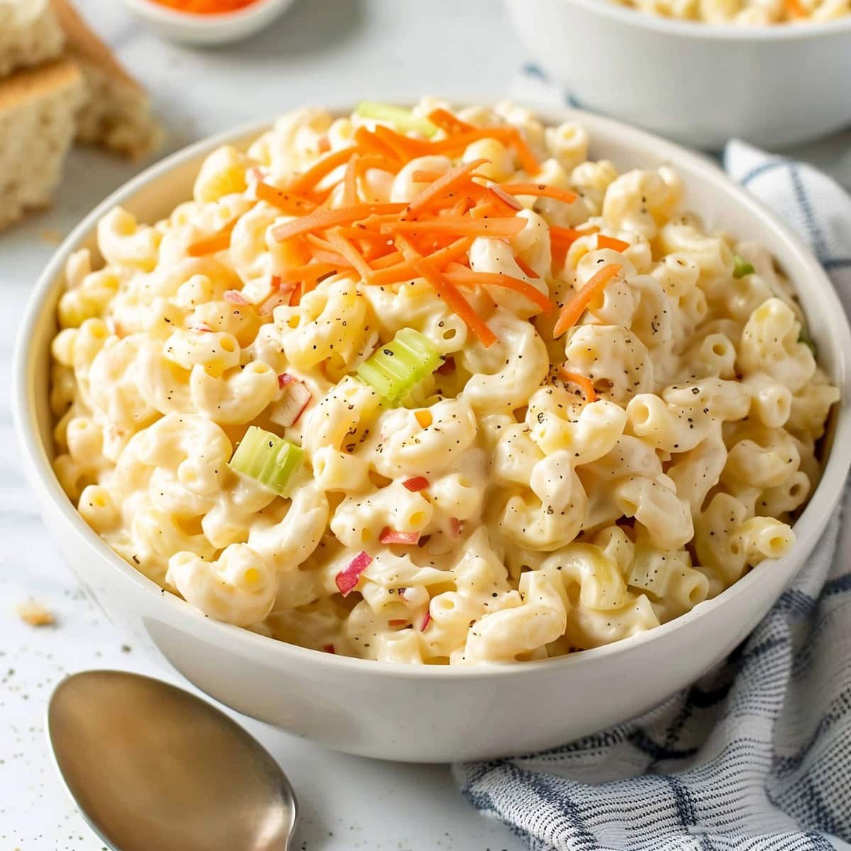 Vibrant Hawaiian macaroni salad, featuring colorful ingredients including carrots, celery and red onions with creamy and tangy dressing
