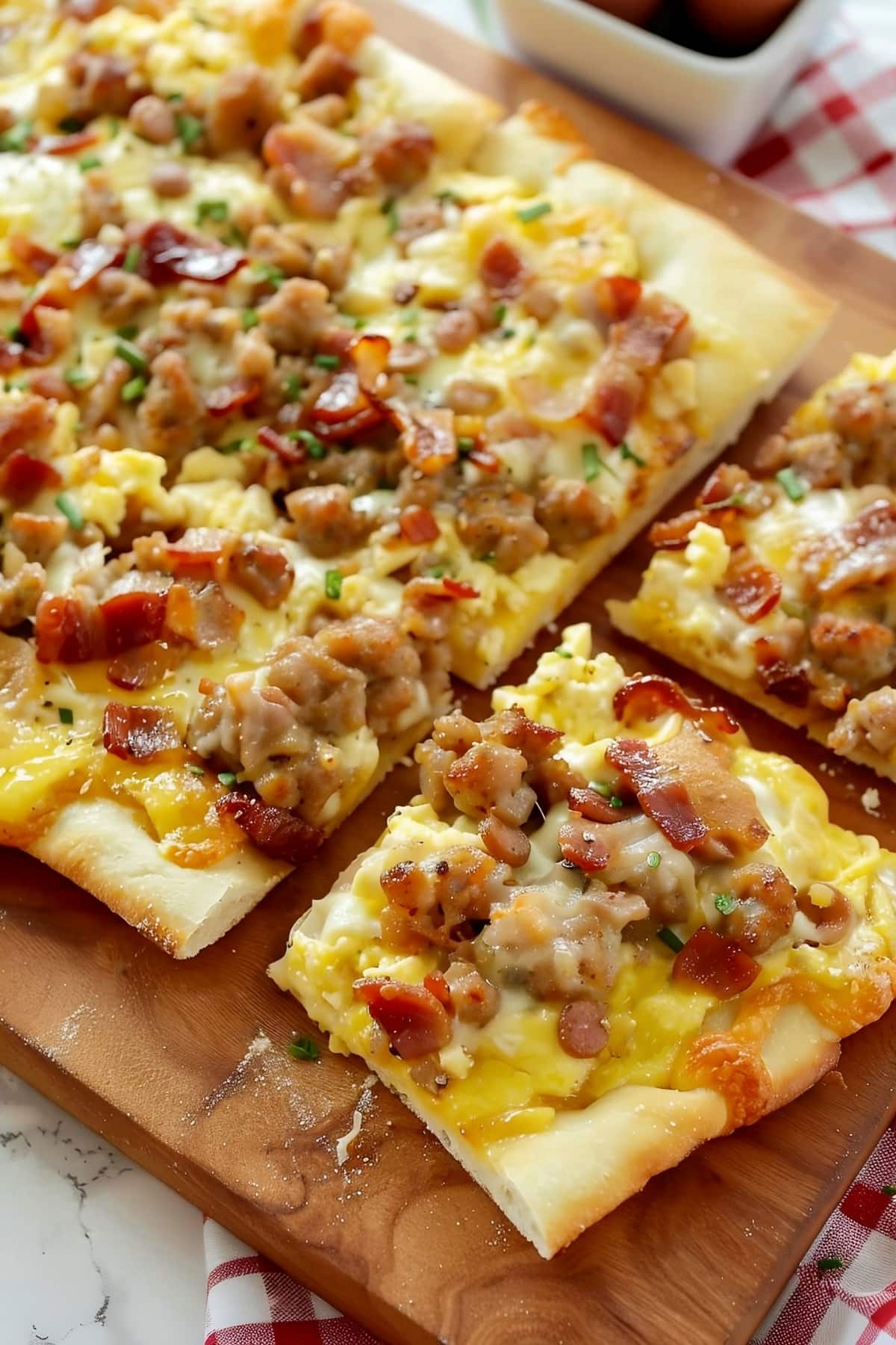 Mouthwatering breakfast pizza with scrambled eggs, sausage, bacon and cheese
