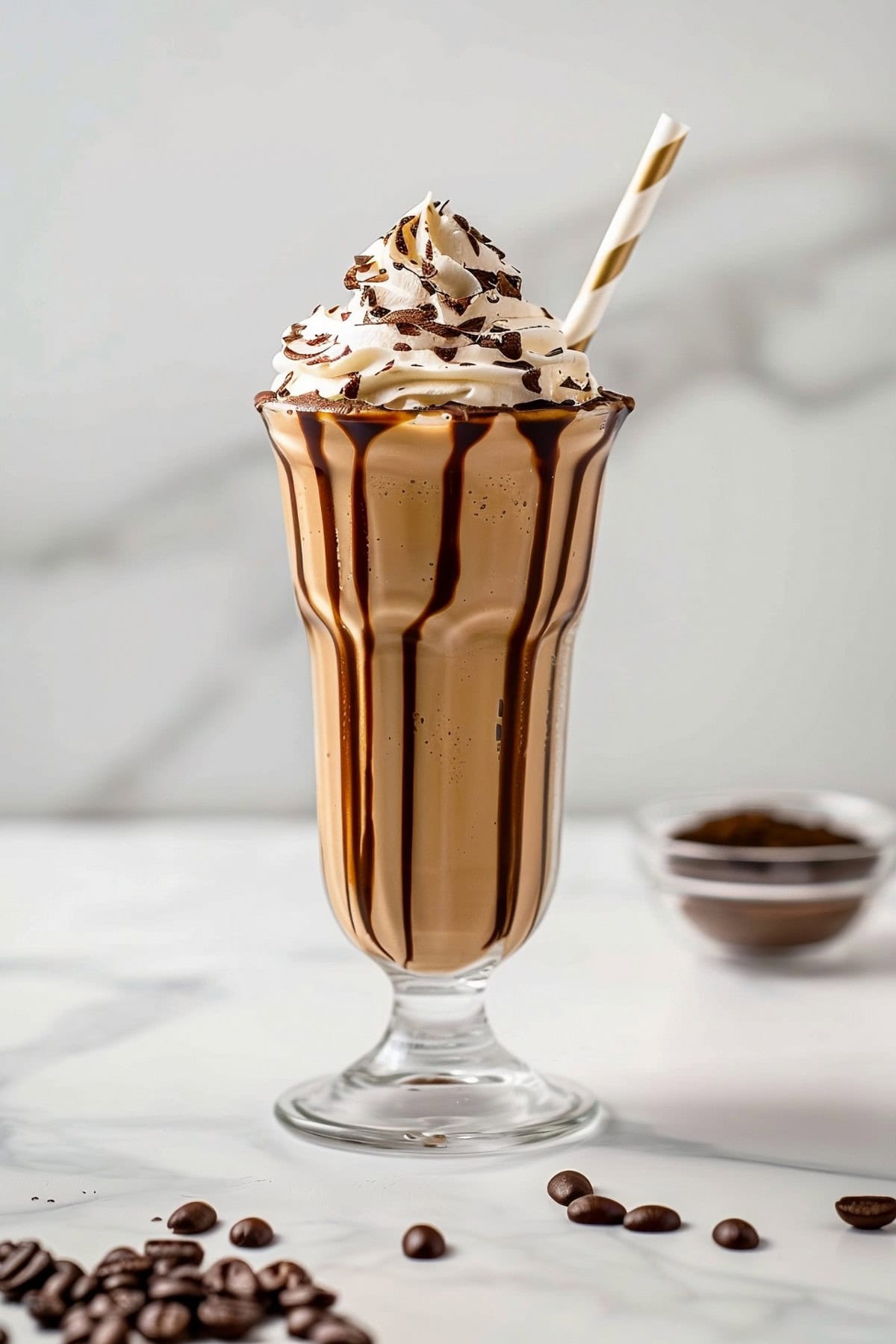 Refreshing coffee milkshake with whipped cream and chocolate sauce
