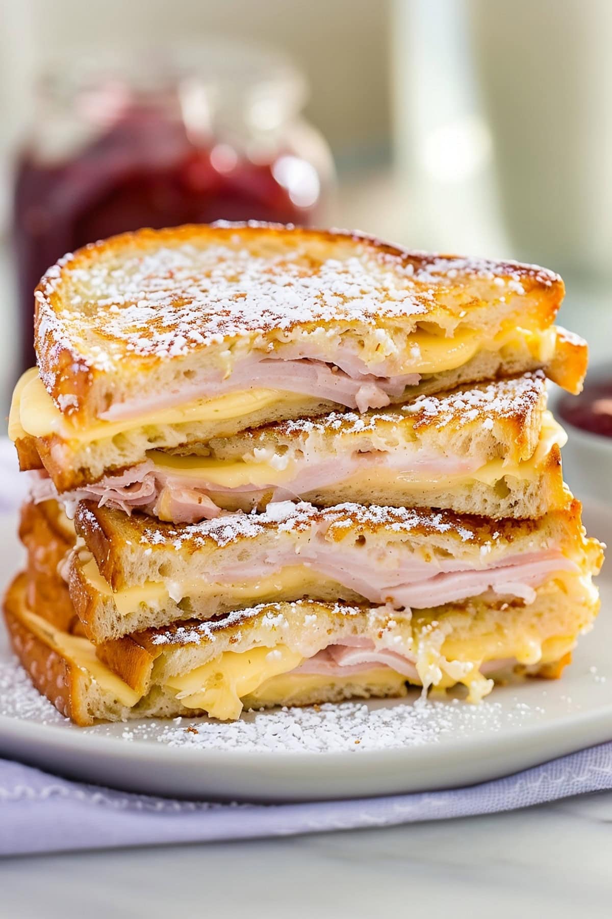 Classic Monte Cristo sandwich, a mouthwatering combination of ham, turkey, and Swiss cheese, dipped in egg batter and grilled to perfection