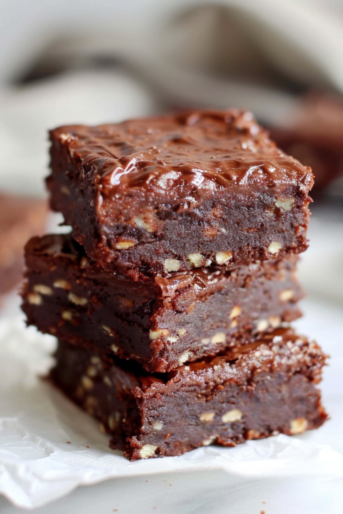 No-bake brownies with nuts and dates stacked on top of each other
