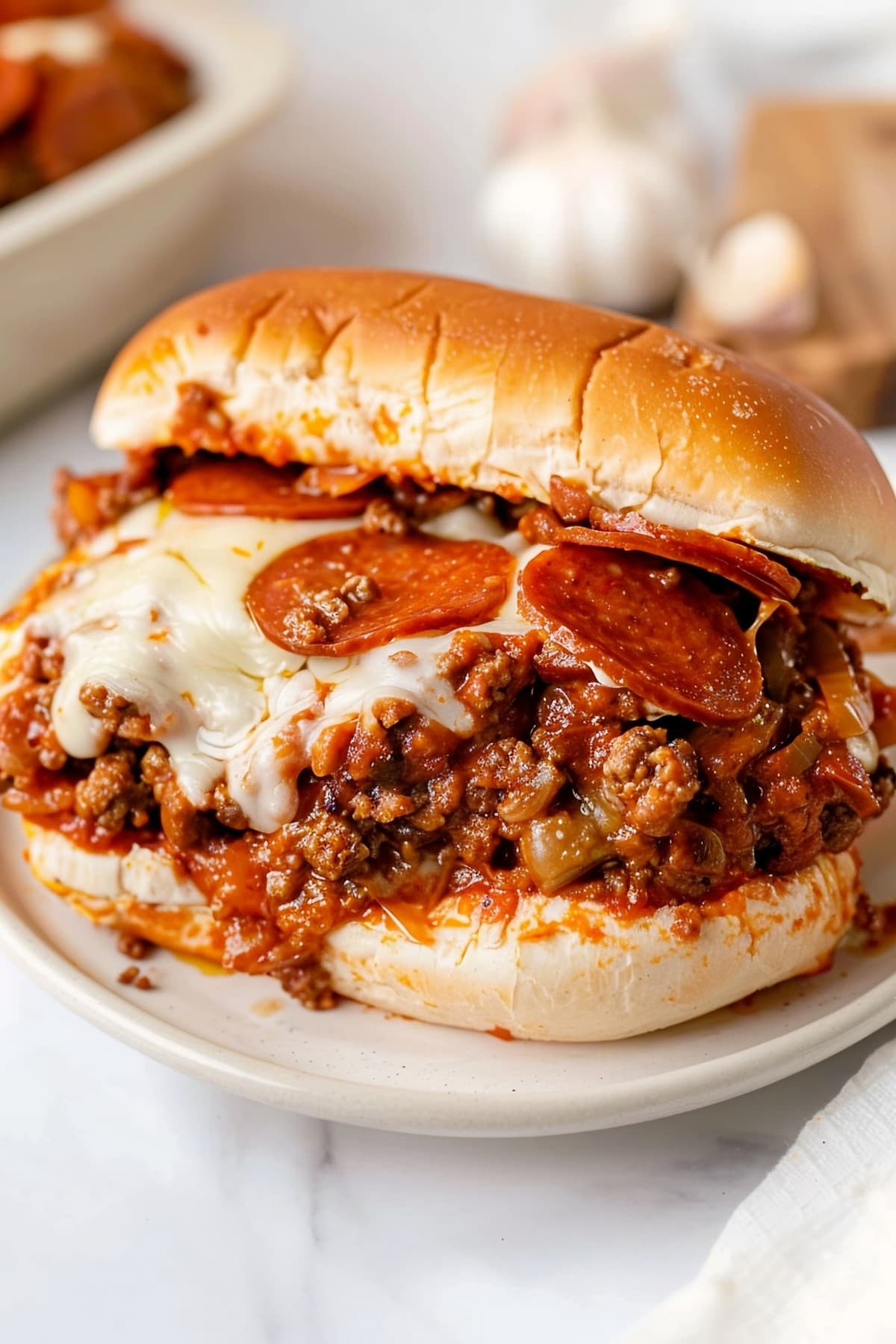 Savory pepperoni pizza sloppy joes, featuring seasoned ground beef, Italian sausage and melted cheese
