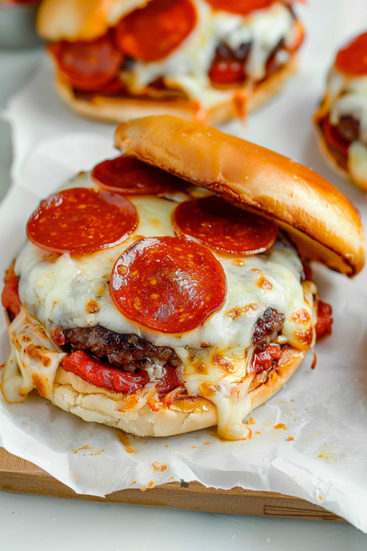 Delectable pizza burgers featuring beef patties, layered with melted cheese and pizza sauce