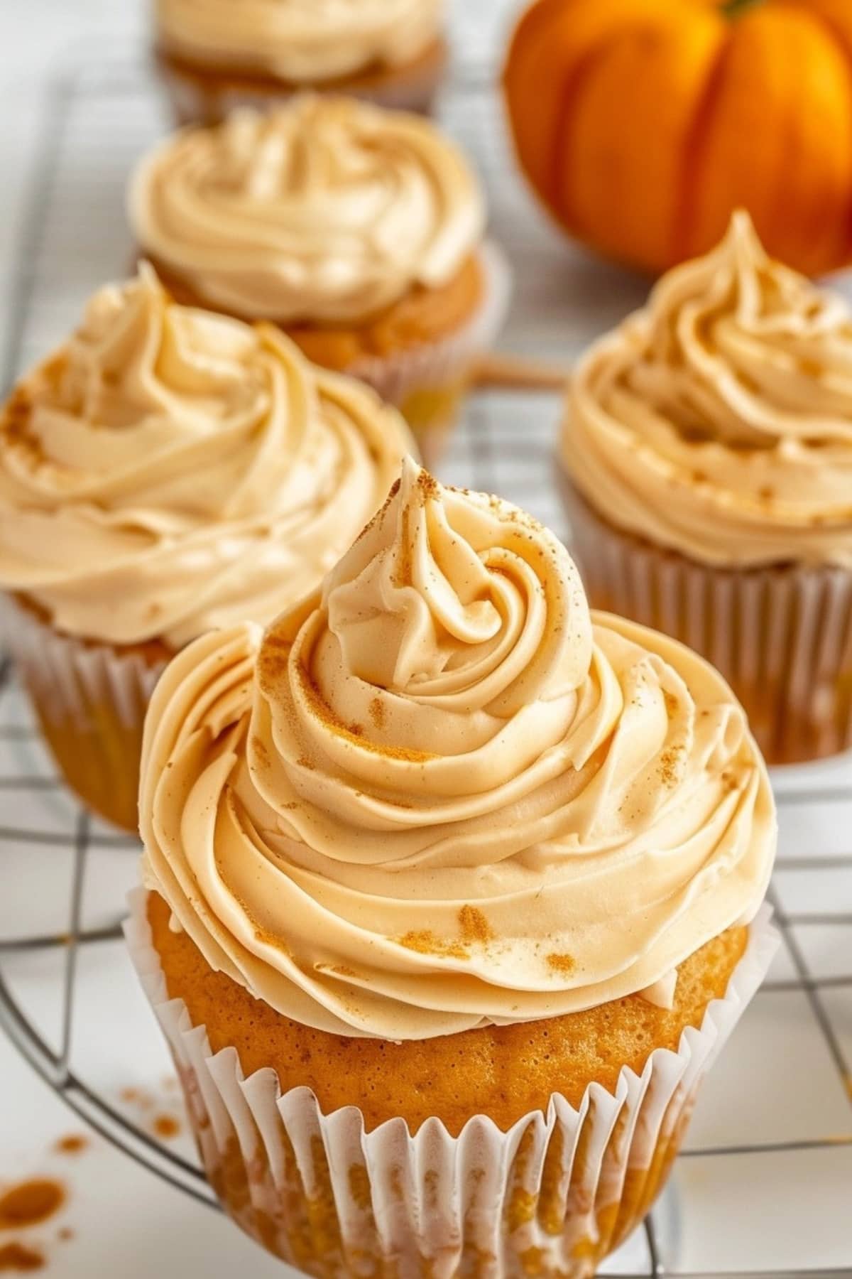 Muffins topped with pumpkin whipped cream.