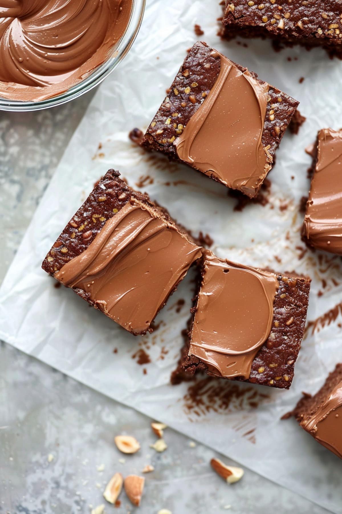 Slices of heavenly no-bake brownies with nuts, topped with chocolate ganache
