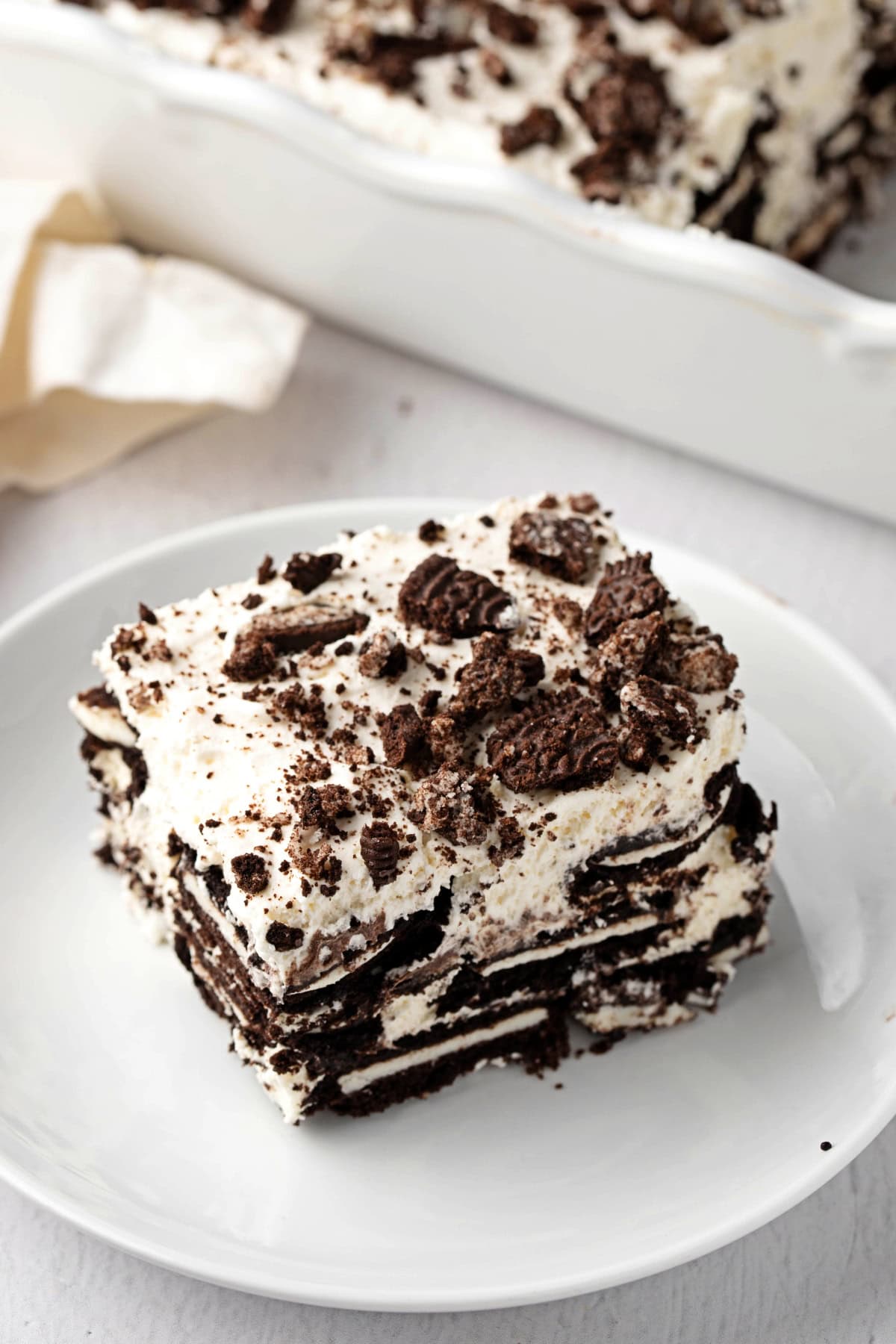 Oreo Icebox cake with whipped cream filling on a plate.