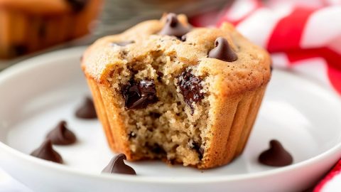 Close-up of a single peanut butter chocolate chip cookie broken in half, revealing gooey melted chocolate inside