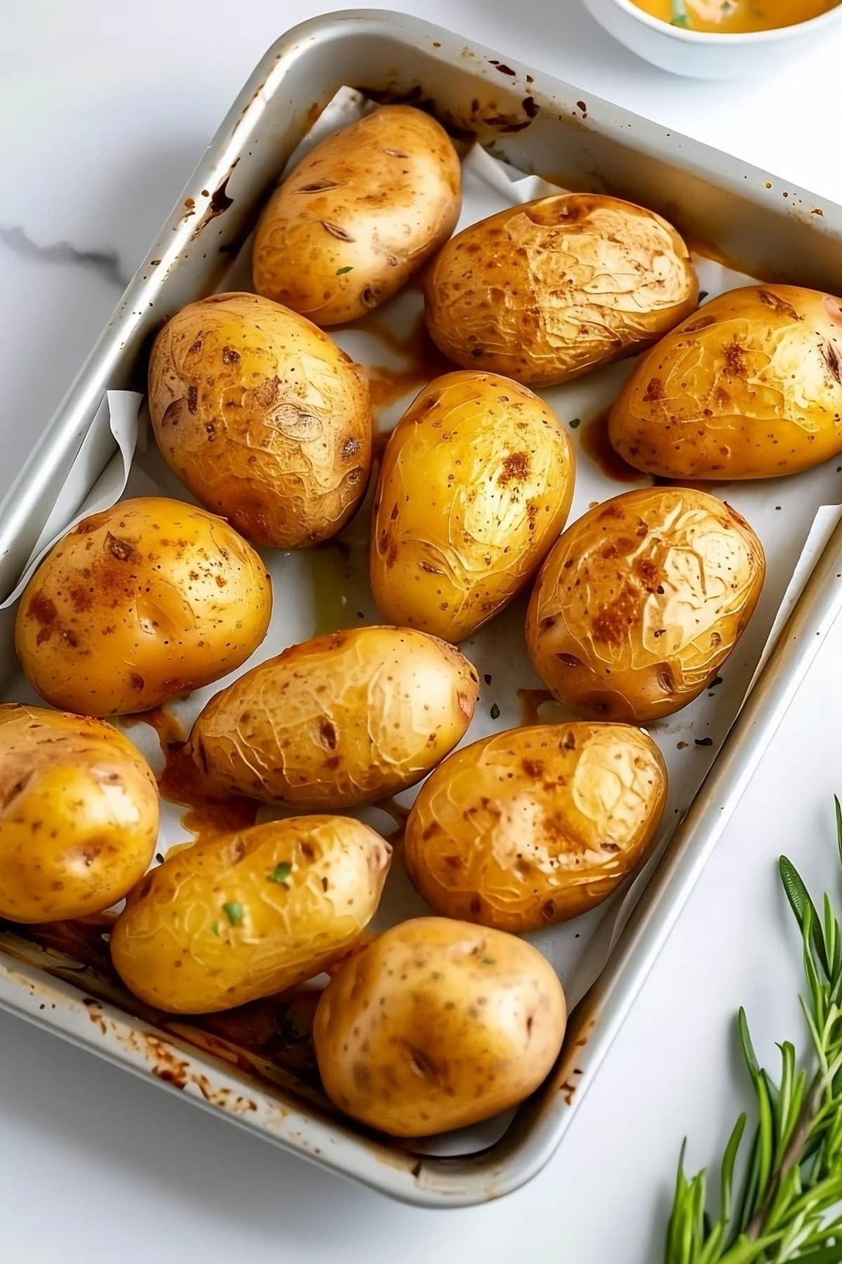 Baked potatoes in a baking sheet.