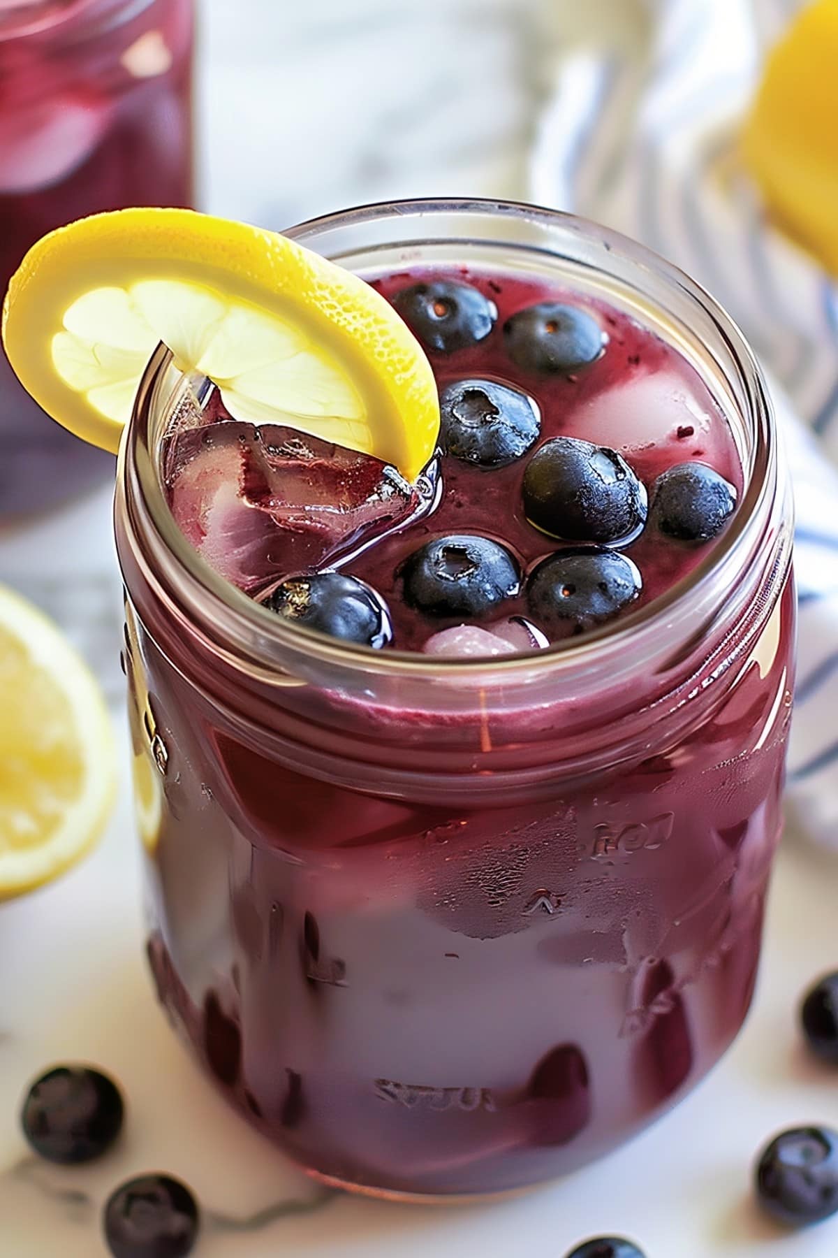 Tangy and sweet blueberry lemonade served over ice, perfect for a hot summer day