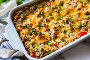 Hearty homemade sausage and rice casserole with colorful ingredients including bell peppers, celery and parsley