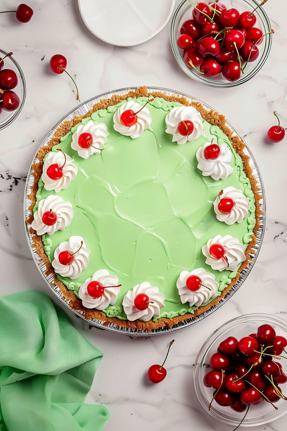 Top down view of Shamrock Shake pie with whipped cream and cherries for garnish