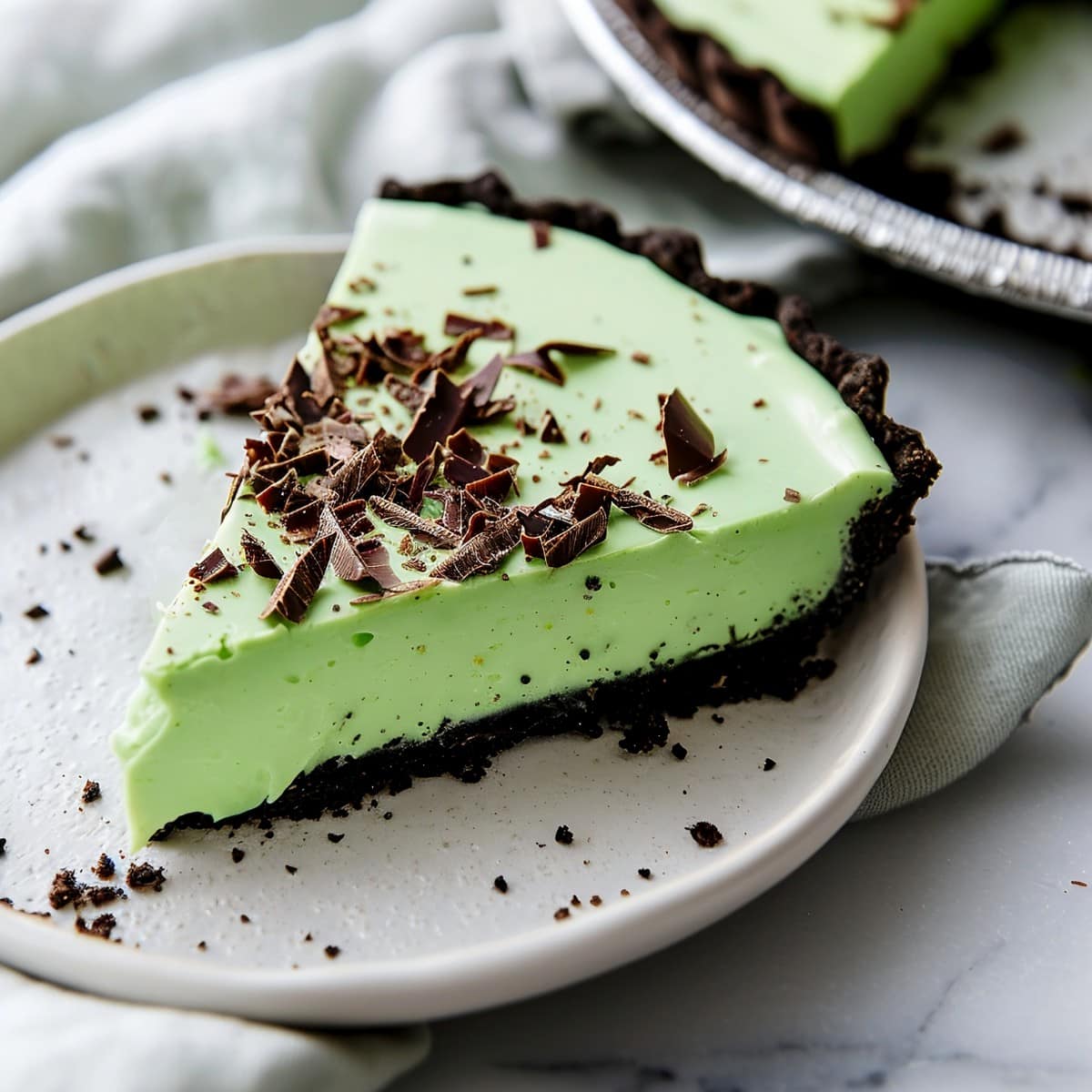 Indulgent grasshopper pie featuring a layer of minty filling topped with chocolate shavings