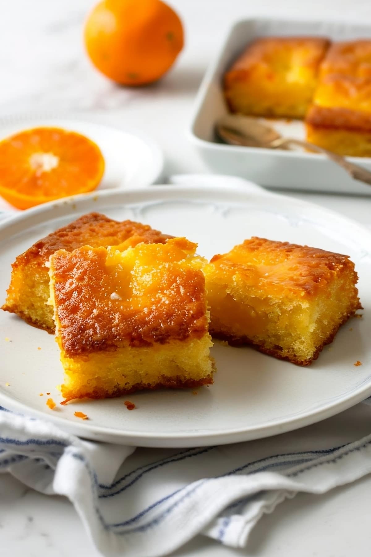 Vibrant orange cake, adorned with citrus slices for a delightful Greek twist