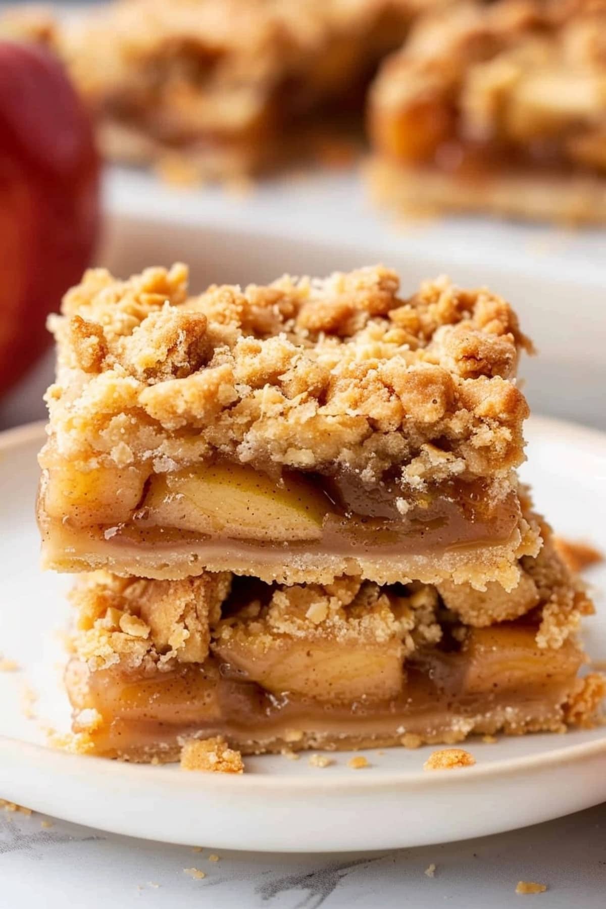 Square slices of apple pie bars in a plate.