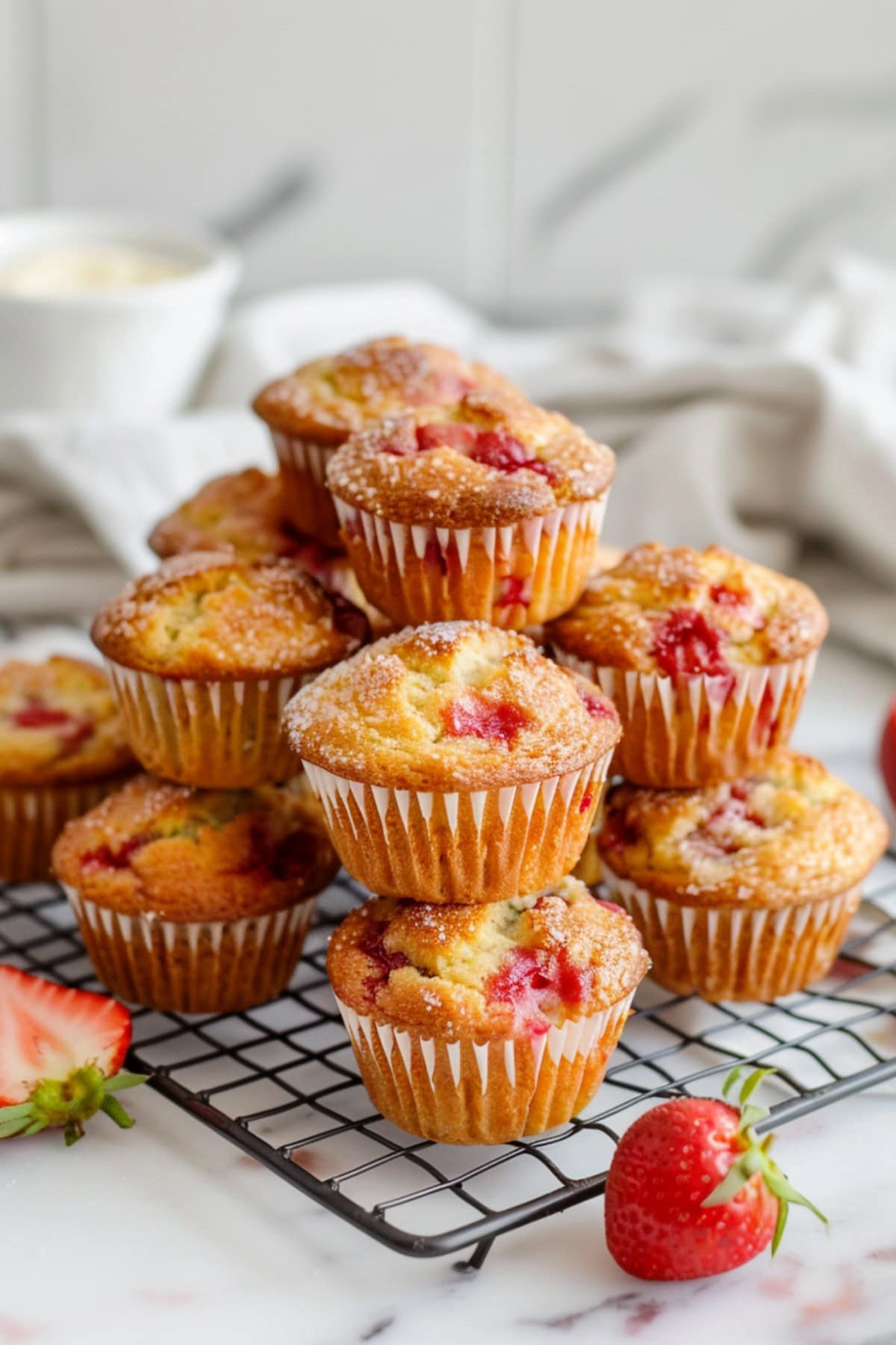 Warm and golden strawberry muffins in a cooling rack fresh from the oven